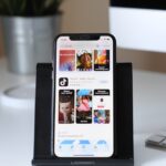 Ein Smartphone auf einem Ständer, auf dem die TikTok-App angezeigt wird.