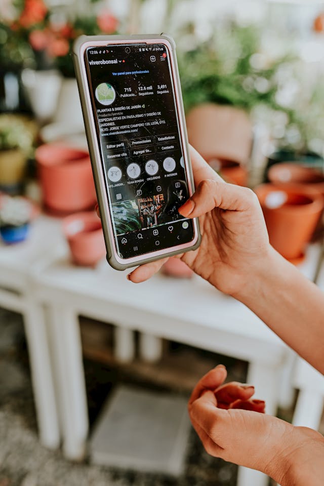 Eine Person scrollt auf ihrem Smartphone durch einen Instagram-Feed.