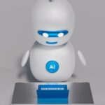 Un seul robot blanc assis devant un ordinateur portable bleu.