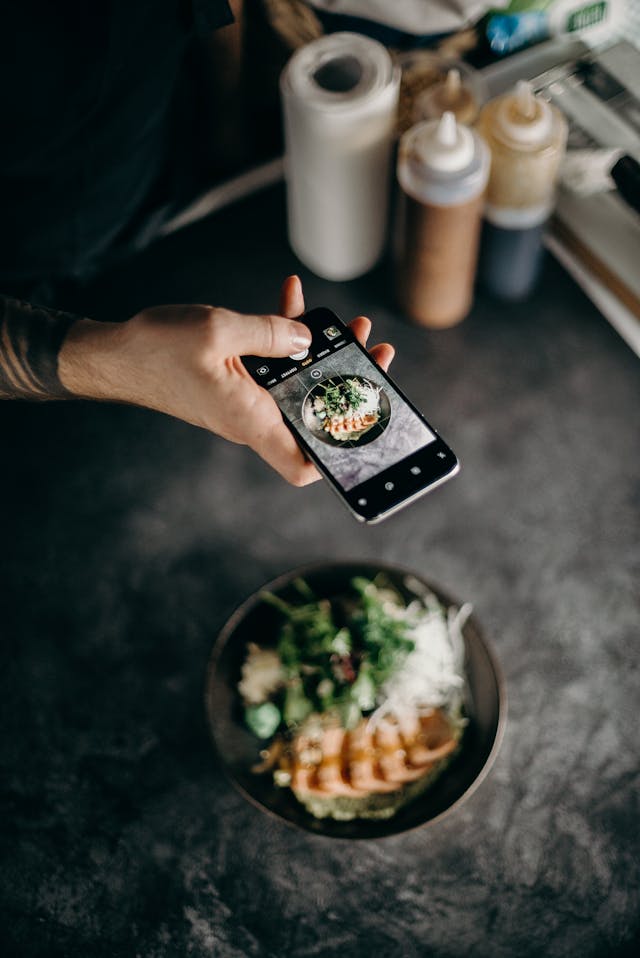Um influenciador gastronómico está a tirar uma fotografia da sua última criação.