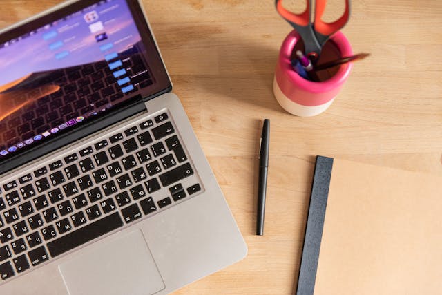 A laptop placed on a wooden table.