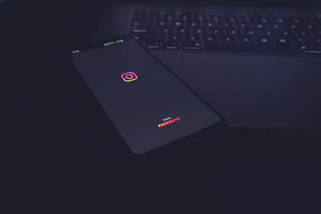 Un telefon pe un birou care arată ecranul de pornire al Instagram.